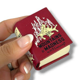 A miniature red book replica of 'The Mountains of Madness' by H.P.