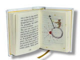 Open book with a page featuring an illustration of a person on the moon and text.