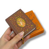 Decorative notebook with a character design held by a hand on a white background, el Rey Leon