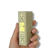 Hand holding a small rectangular box with decorative design and 'Disney' branding on a white background 102 Dalmatas