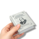 Small book titled 'The Quotable Winston Churchill' held by a hand on a white background