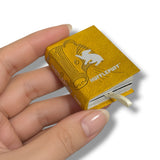 A miniature yellow Hufflepuff handbook held in a person's hand, featuring the Hufflepuff bird logo and text on the cover.