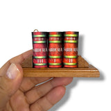 Three books titled 'Sabiduria' on a wooden stand held by a hand against a white background