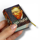 Miniature book with Van Gogh's portrait on the cover held by a hand.